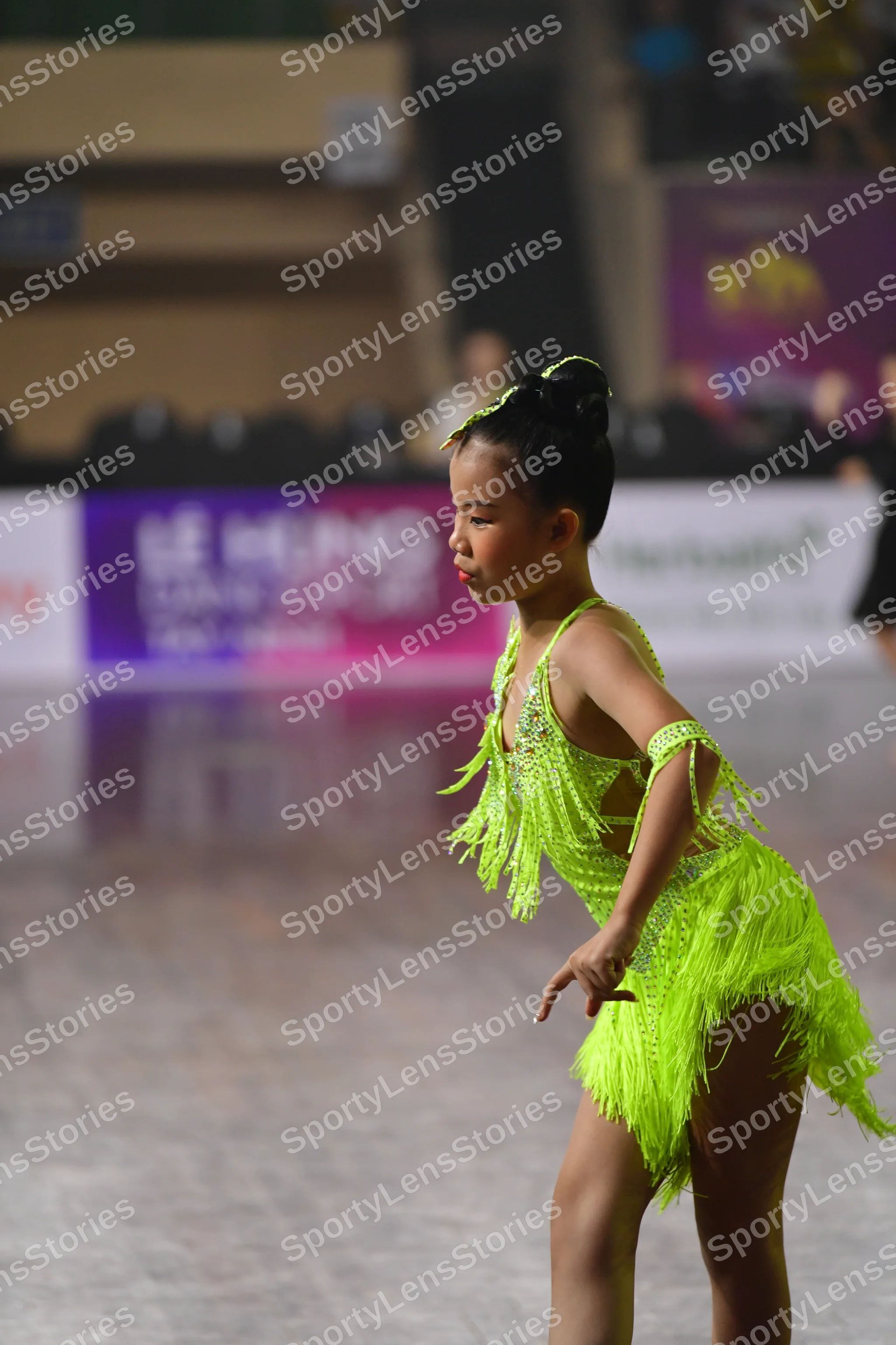 Dancesport competitor: Female dancer: lime green latin dress with long fringe