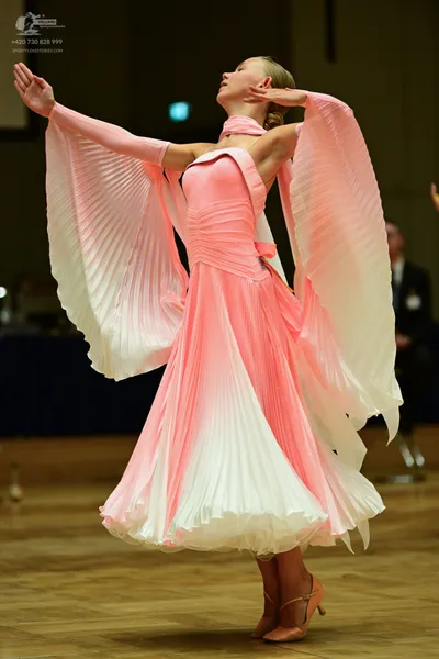Dancesport competitor: **  White and pale pink pleated full-length gown