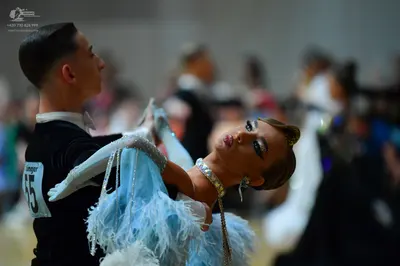 Dancesport competitor #55: Male dancer: black long-sleeved dance top with a white collar