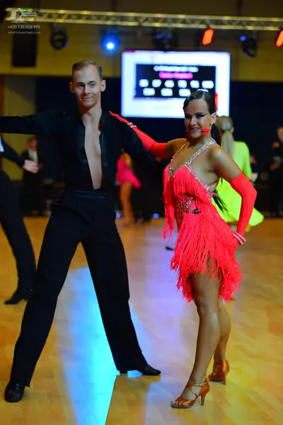 Dancesport competitor: Male dancer: black long-sleeved shirt with a deep V-neck and black trousers