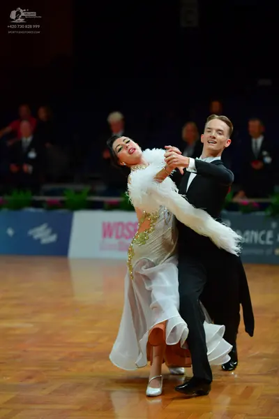 Dancesport competitor: Male dancer: black suit with a white shirt and black bow tie