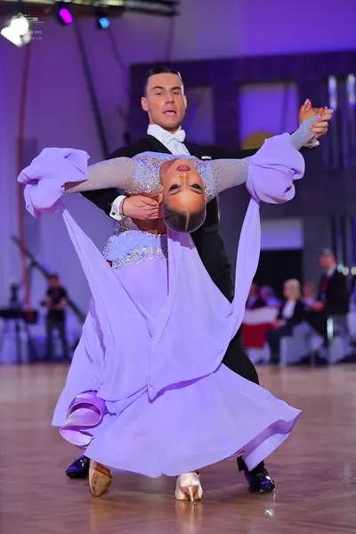 Dancesport competitor: Male dancer: black suit with a white shirt and white bowtie