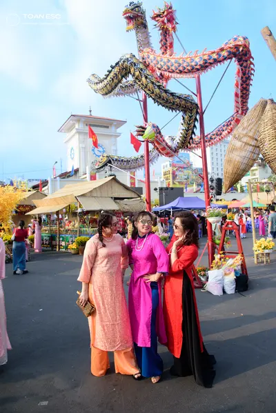 Dancesport competitor: Three female dancers are wearing traditional Vietnamese Áo dài