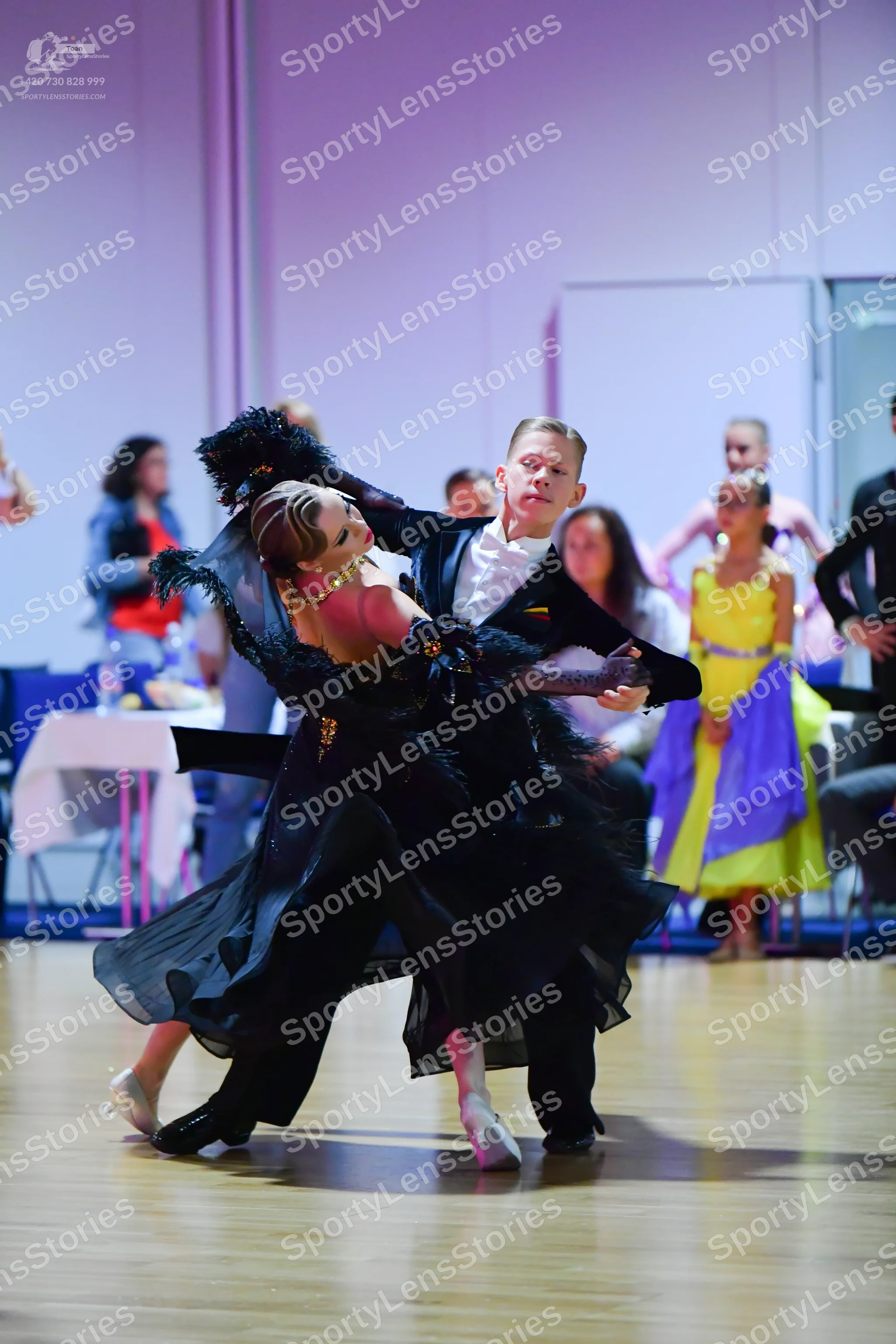 Dancesport competitor: Male dancer: black suit with a white shirt