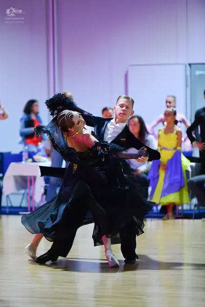 Dancesport competitor: Male dancer: black suit with a white shirt