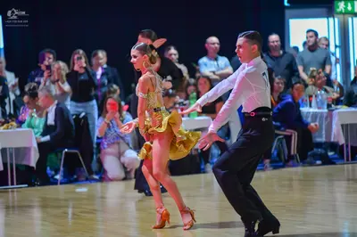 Dancesport competitor #36: Male dancer: white long-sleeved shirt, black trousers, and a black belt with a r