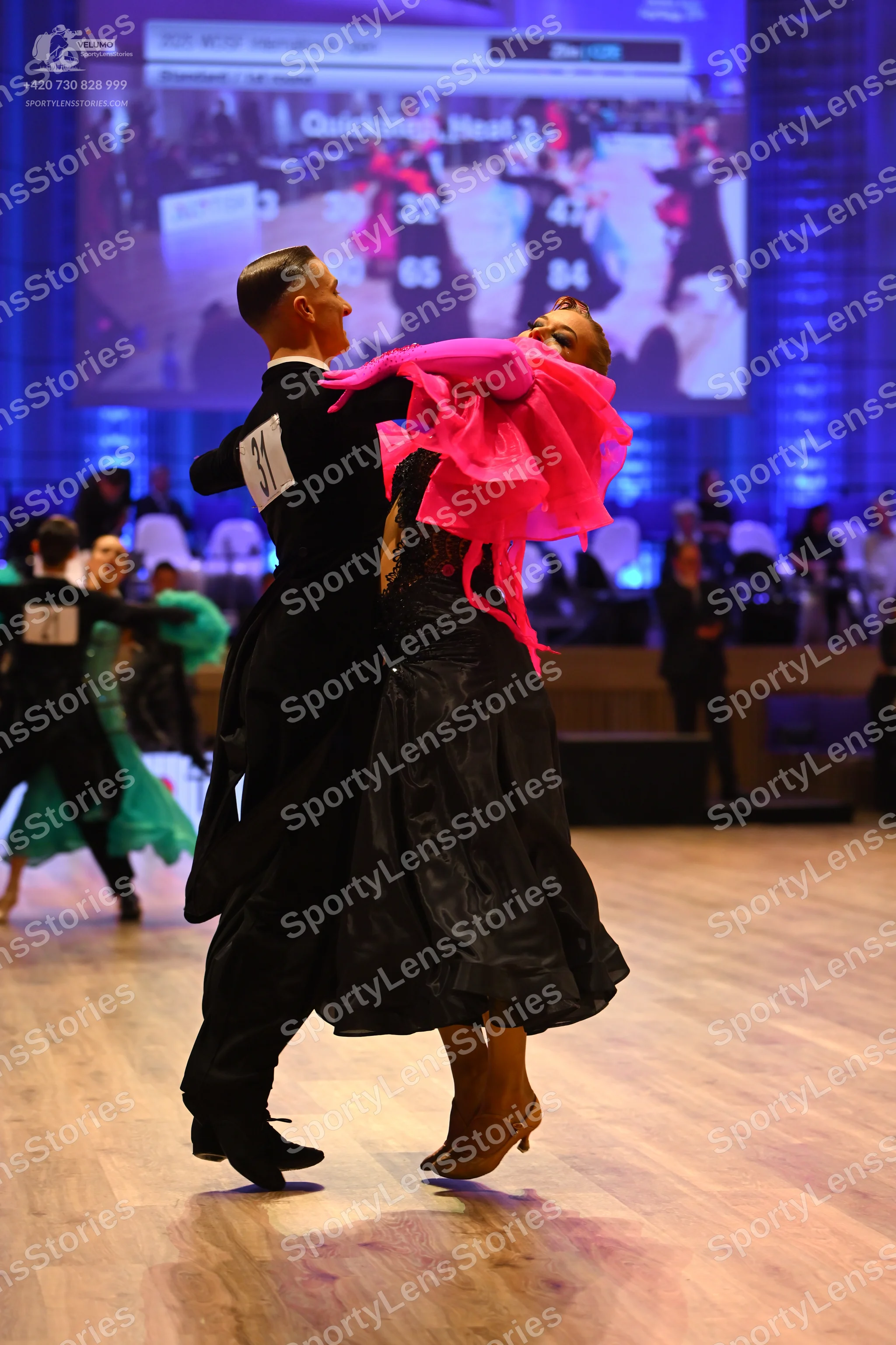 Dancesport competitor: Male dancer: black suit, black shirt, and black trousers