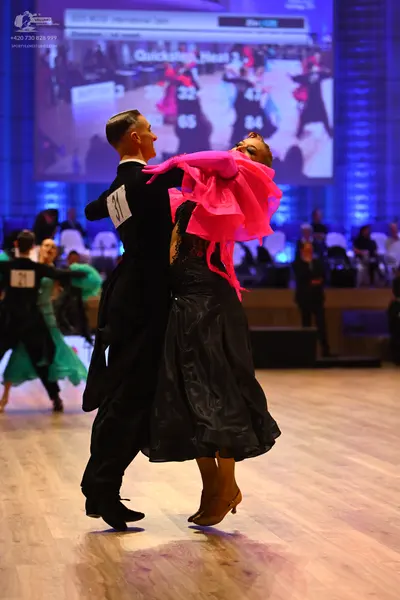 Dancesport competitor: Male dancer: black suit, black shirt, and black trousers