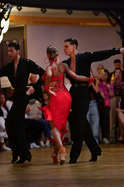 Dancesport competitor: Male dancers: black long-sleeved shirts and black trousers