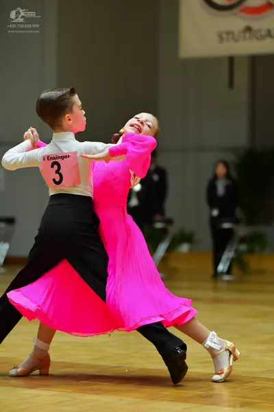 Dancesport competitor: Male dancer: white long-sleeved shirt and black trousers