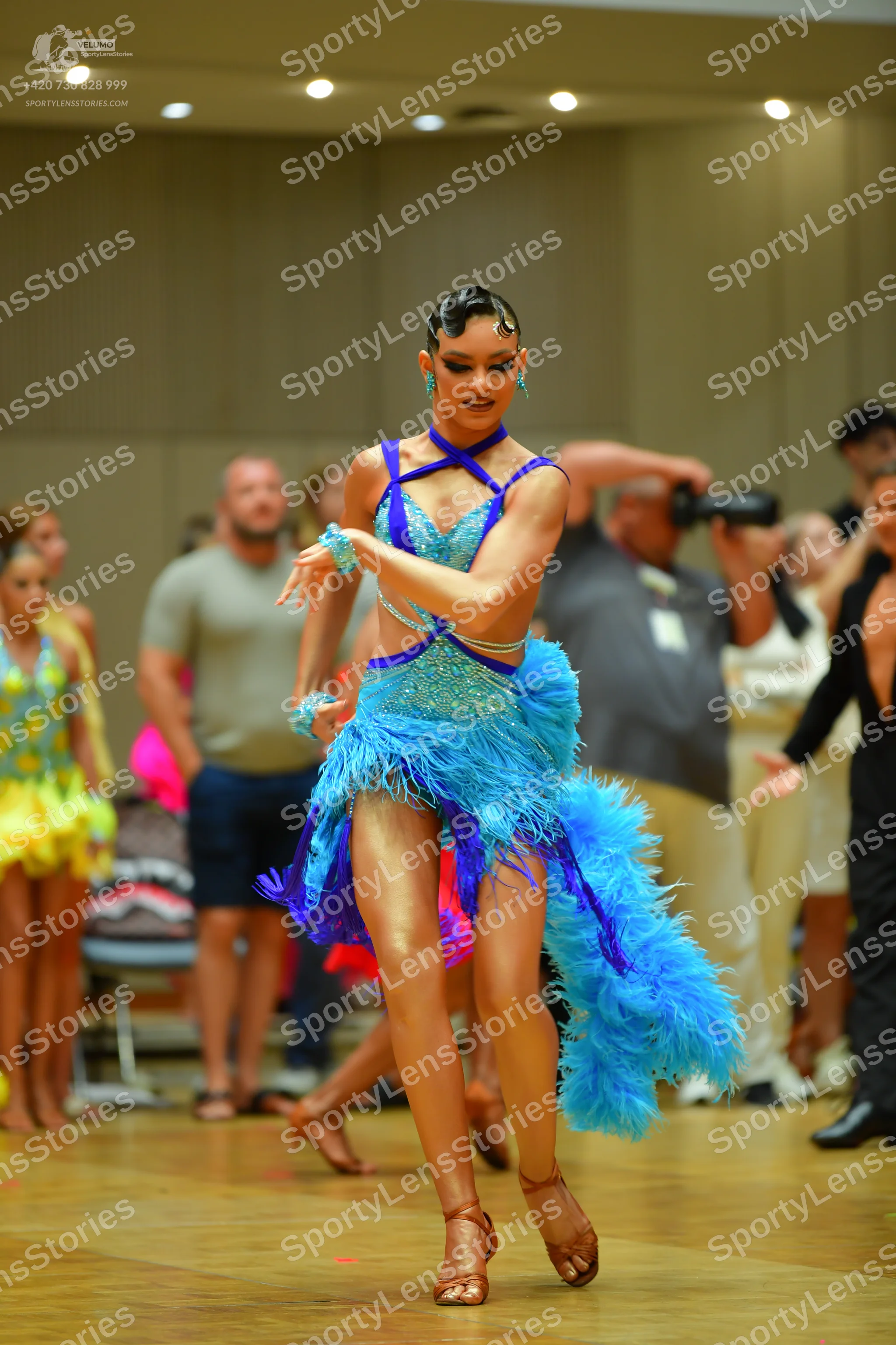 Dancesport competitor: Main dancer: bright blue and dark blue Latin dance dress with a sequin bodice an