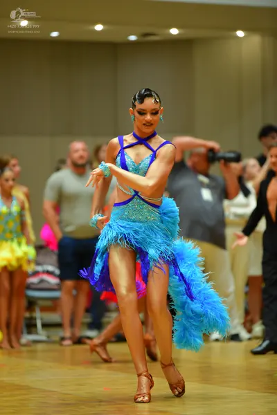 Dancesport competitor: Main dancer: bright blue and dark blue Latin dance dress with a sequin bodice an