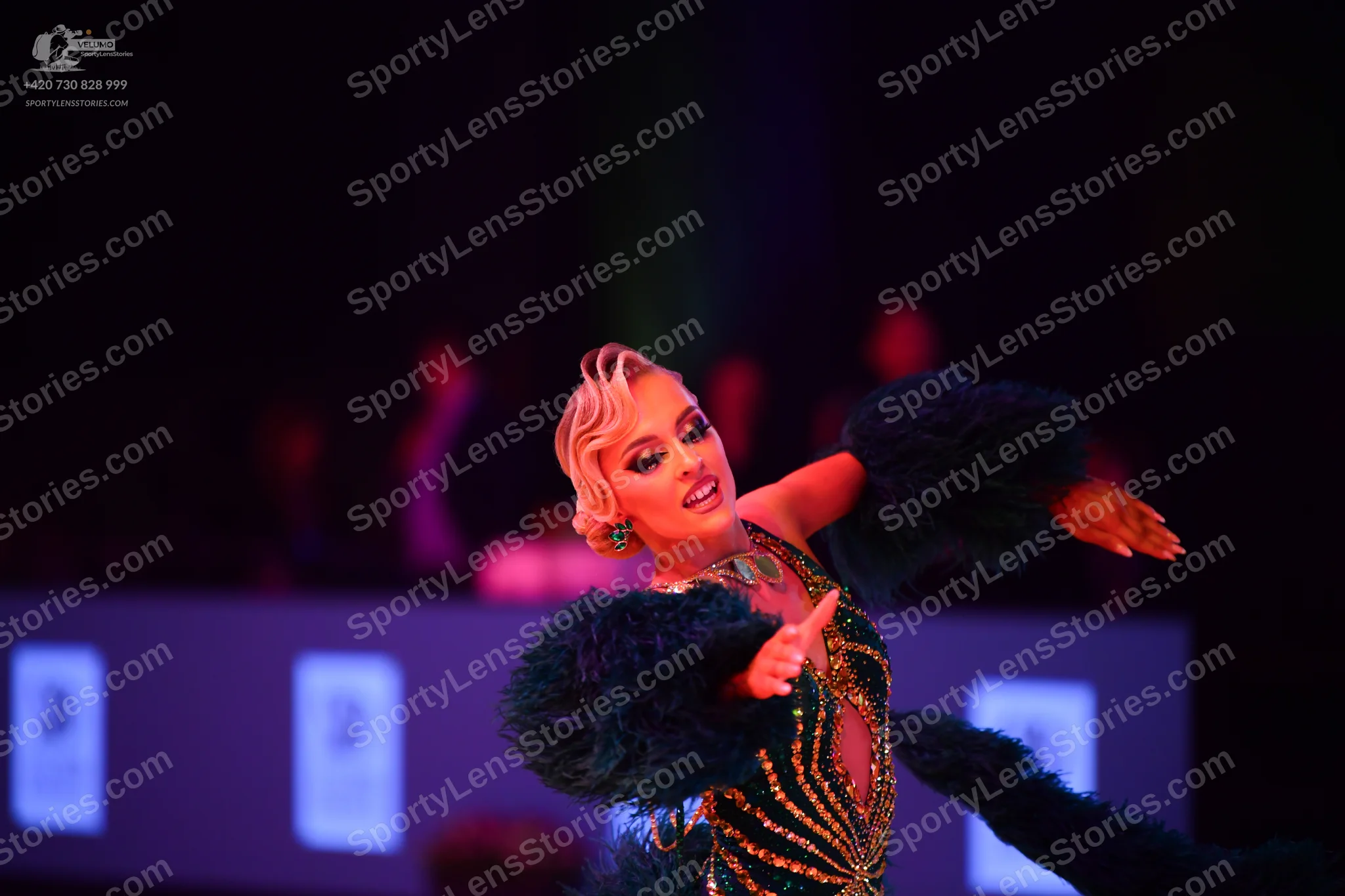Dancesport competitor: Female dancer: dark green latin dress with gold/yellow sequin/beaded patterns an