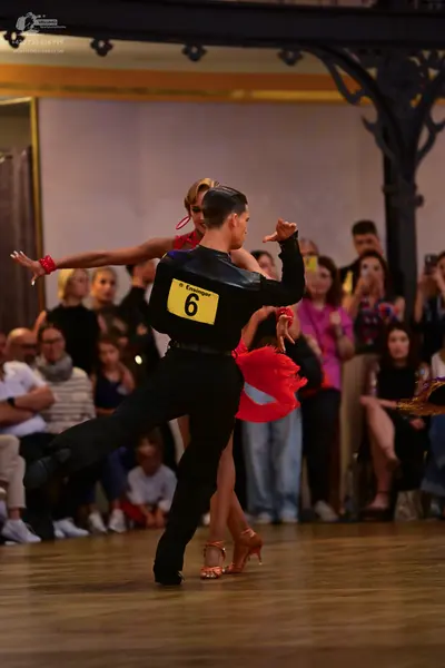 Dancesport competitor: Male dancer: black long-sleeved shirt and black trousers