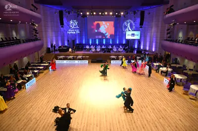 Dancesport competitor: Male dancer (foreground): black suit with white shirt