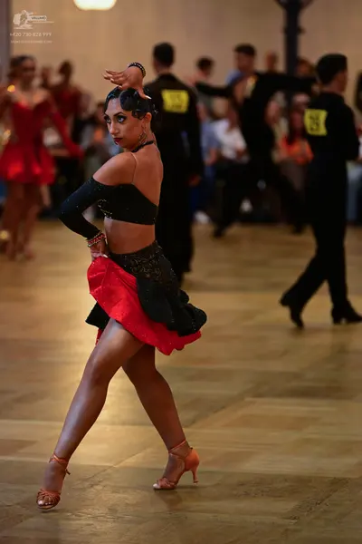 Dancesport competitor #73, #29: Main female dancer: black long-sleeved crop top with sheer sleeves, black sequin