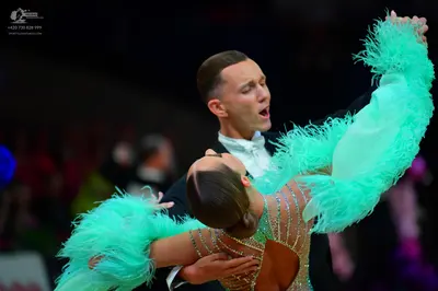 Dancesport competitor: Male dancer: black suit with a white shirt and white bowtie