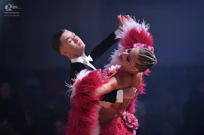 Dancesport competitor: Male dancer: black suit with white shirt and white bow tie