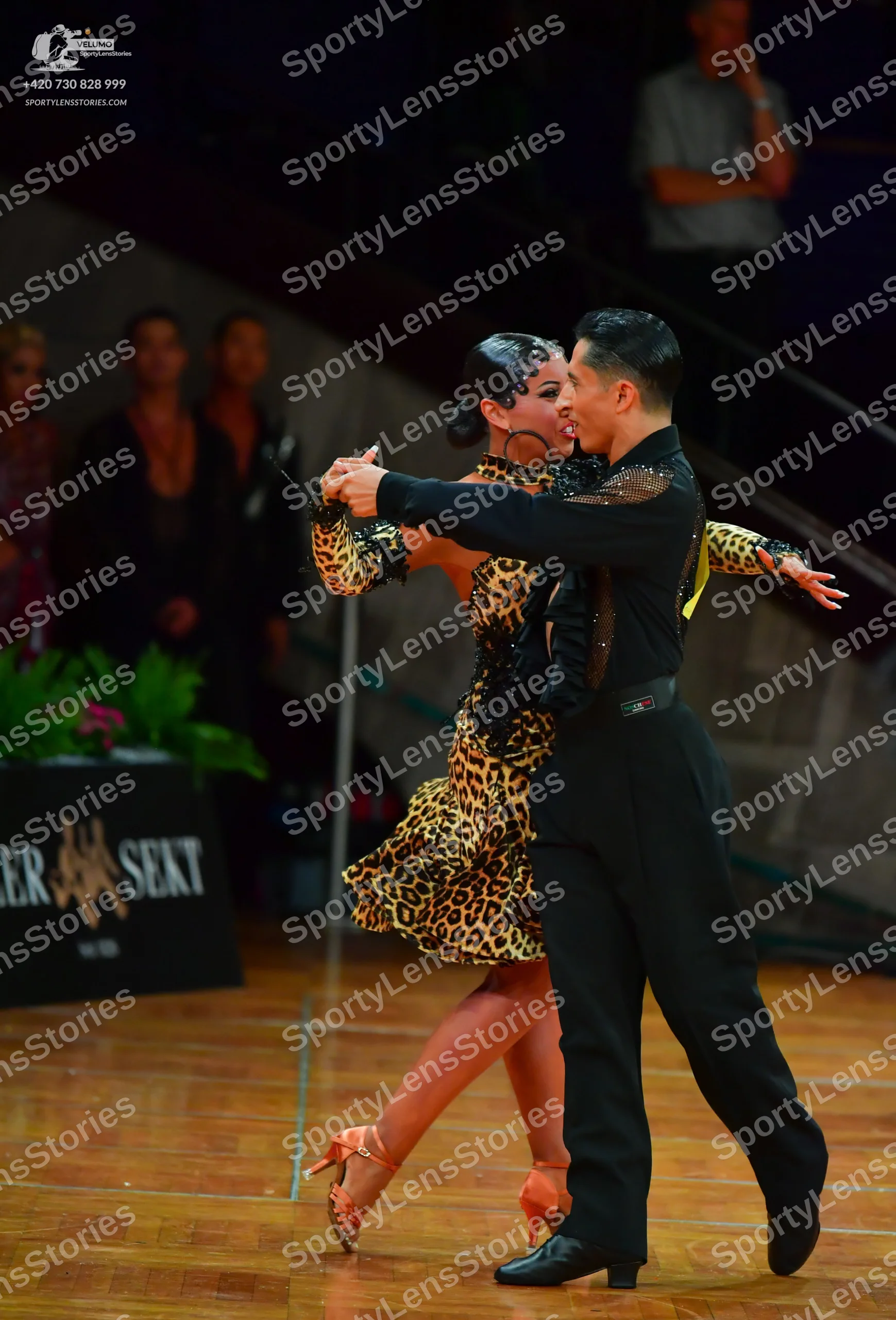 Dancesport competitor: Male dancer: black long-sleeved shirt with black sequin embellishments on the sh