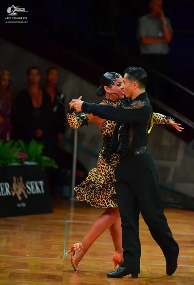 Dancesport competitor: Male dancer: black long-sleeved shirt with black sequin embellishments on the sh
