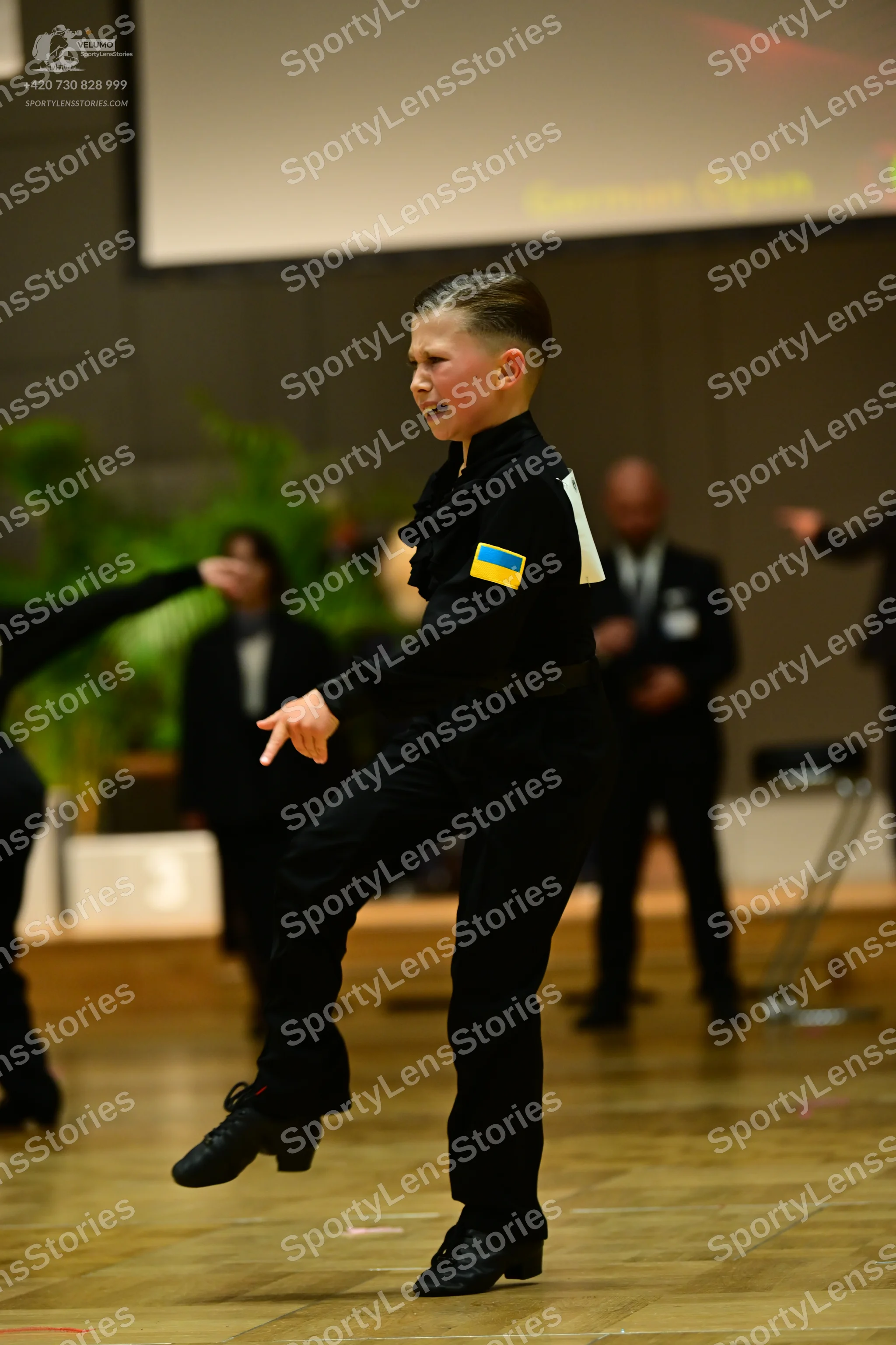 Dancesport competitor: Main dancer: black long-sleeved shirt with a ruffled collar and a small Ukrainia