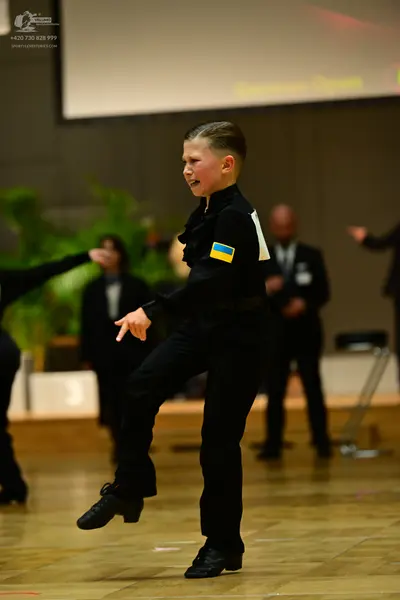 Dancesport competitor: Main dancer: black long-sleeved shirt with a ruffled collar and a small Ukrainia