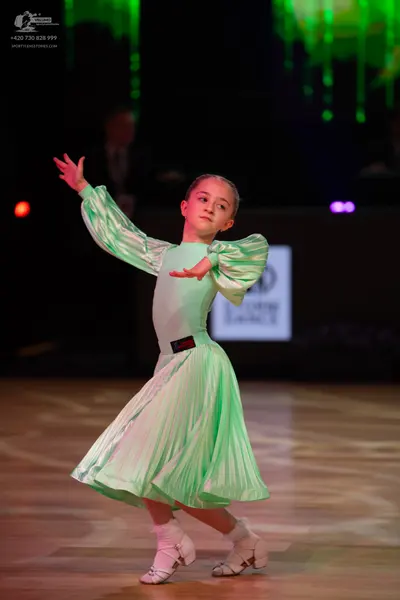 Dancesport competitor: Female dancer: mint green long-sleeved dress with puffy, pleated sleeves and a p