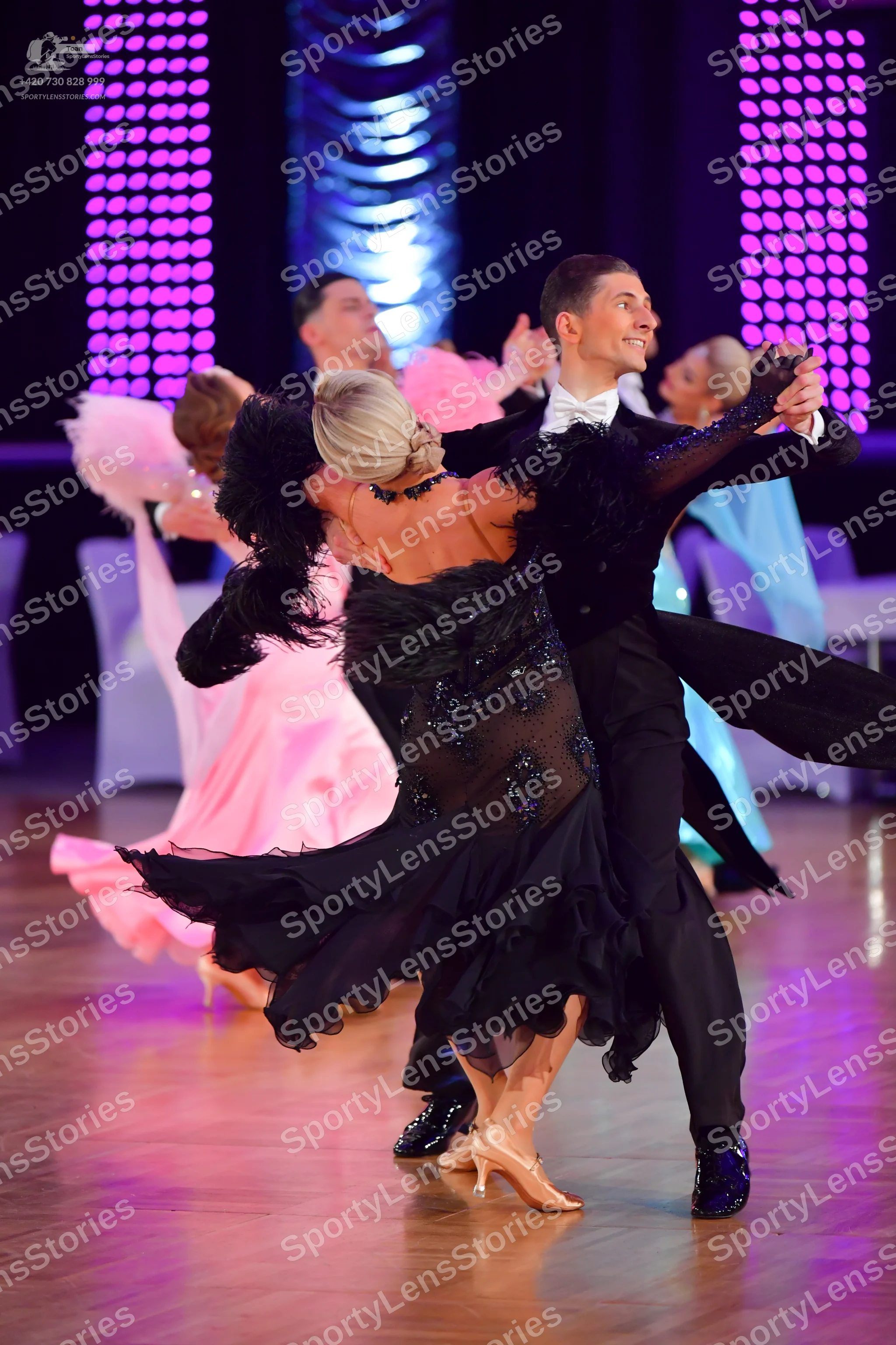 Dancesport competitor: Main female dancer: black dance dress with feathers on the bodice and a sequined
