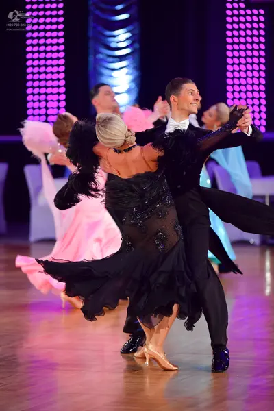 Dancesport competitor: Main female dancer: black dance dress with feathers on the bodice and a sequined