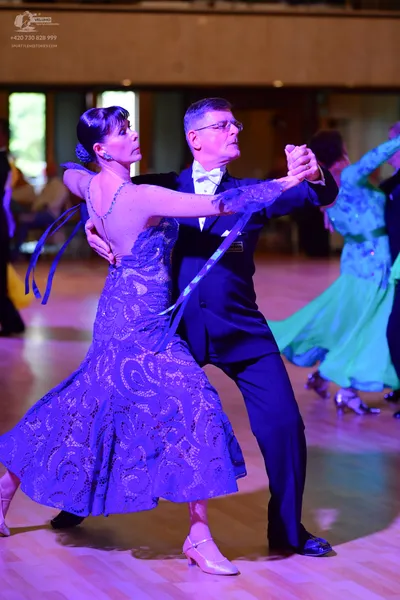 Dancesport competitor: Male** 
*   **Color:** Black
*   **Fabric:** Sequined (appears to be a satin or 