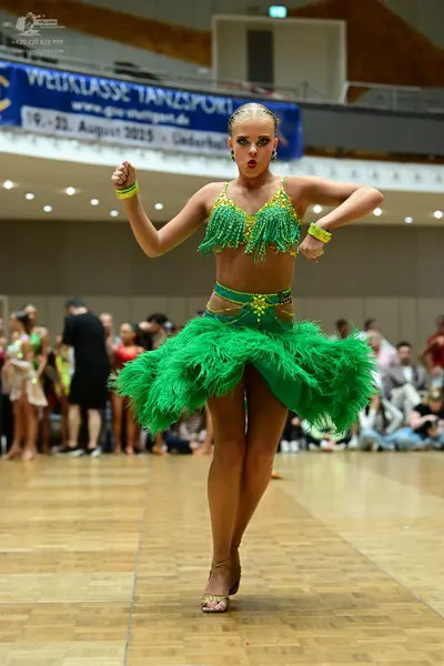 Dancesport competitor: Female dancer: bright green two-piece latin costume featuring a sequined/beaded 