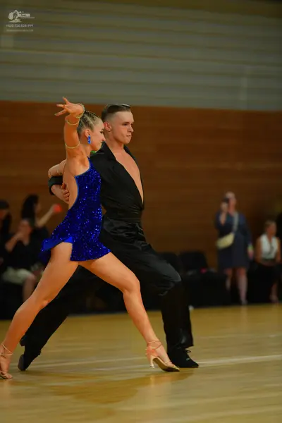 Dancesport competitor: Male:** Black tailsuit with sequin lapels