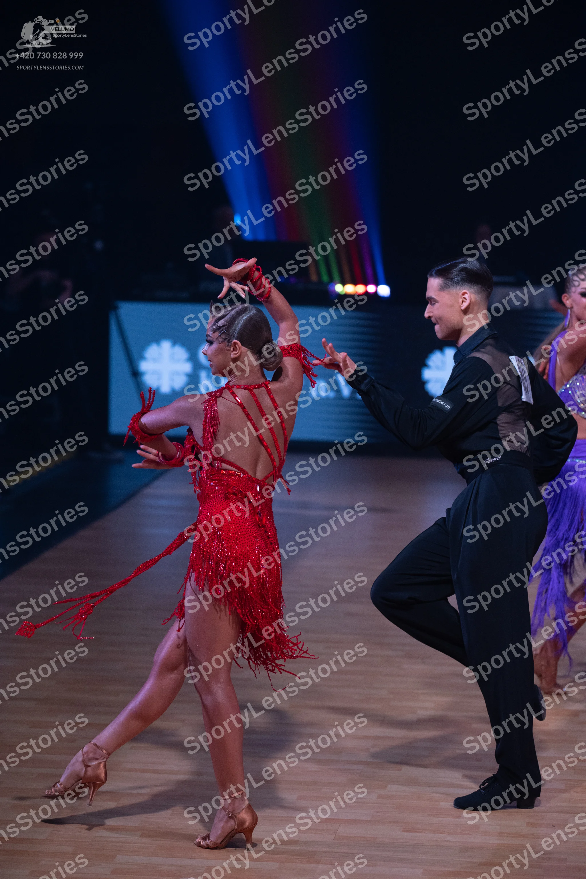 Dancesport competitor: Female dancer (red): red latin dress with long fringe