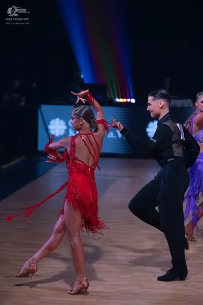 Dancesport competitor: Female dancer (red): red latin dress with long fringe