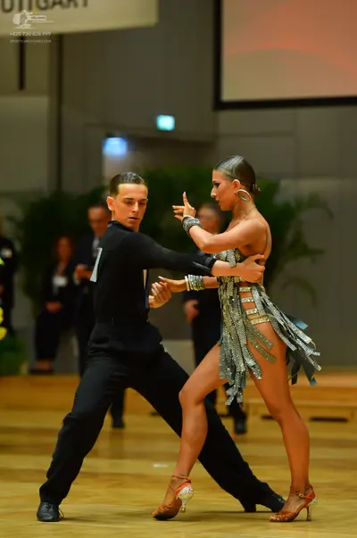 Dancesport competitor: Male dancer: black long-sleeved shirt and black trousers