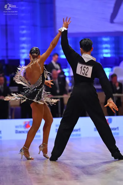 Dancesport competitor: Male dancer: black long-sleeved shirt and black trousers