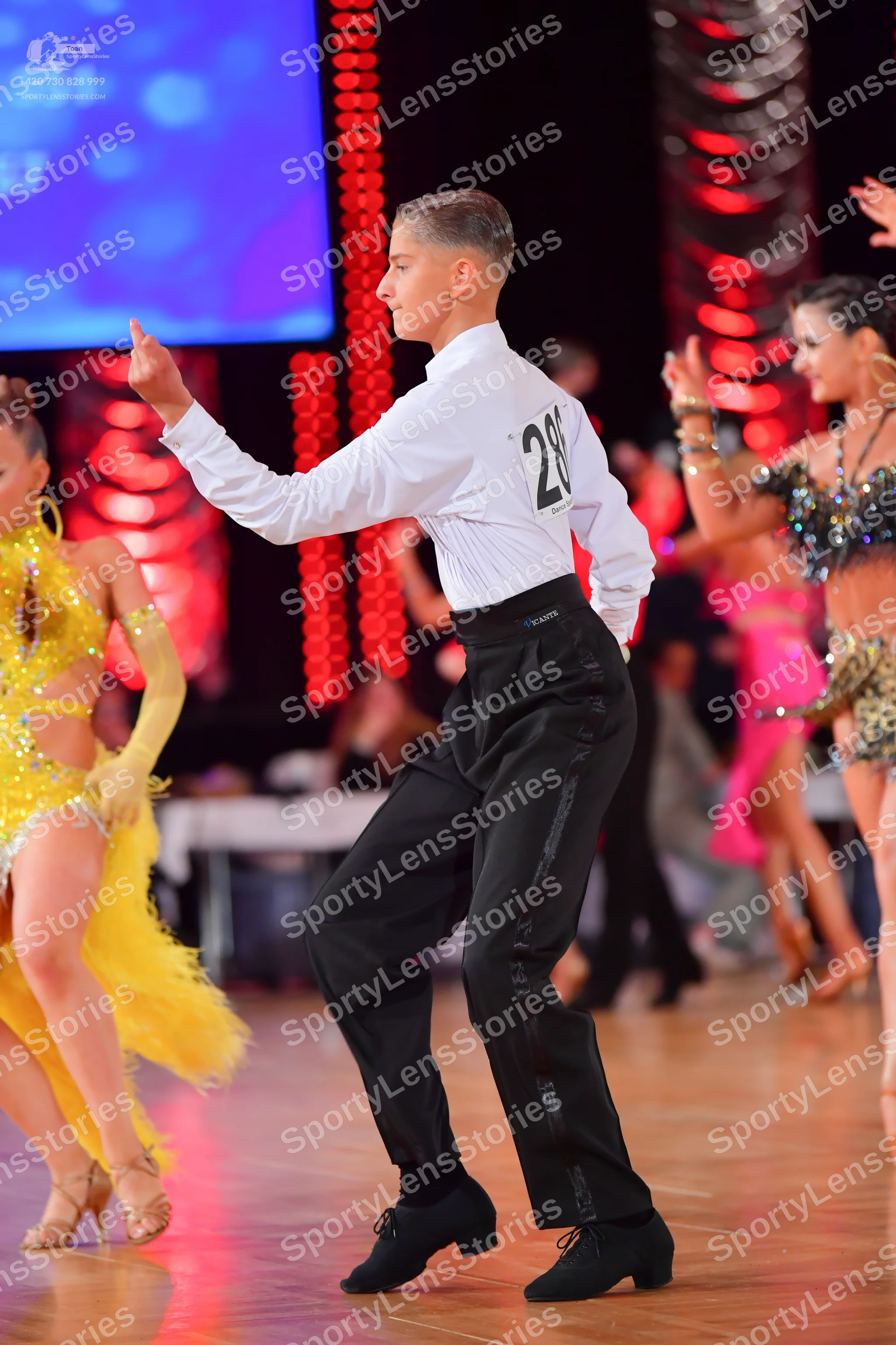 Dancesport competitor #28: Male dancer: white long-sleeved shirt and black trousers with a sequined stripe