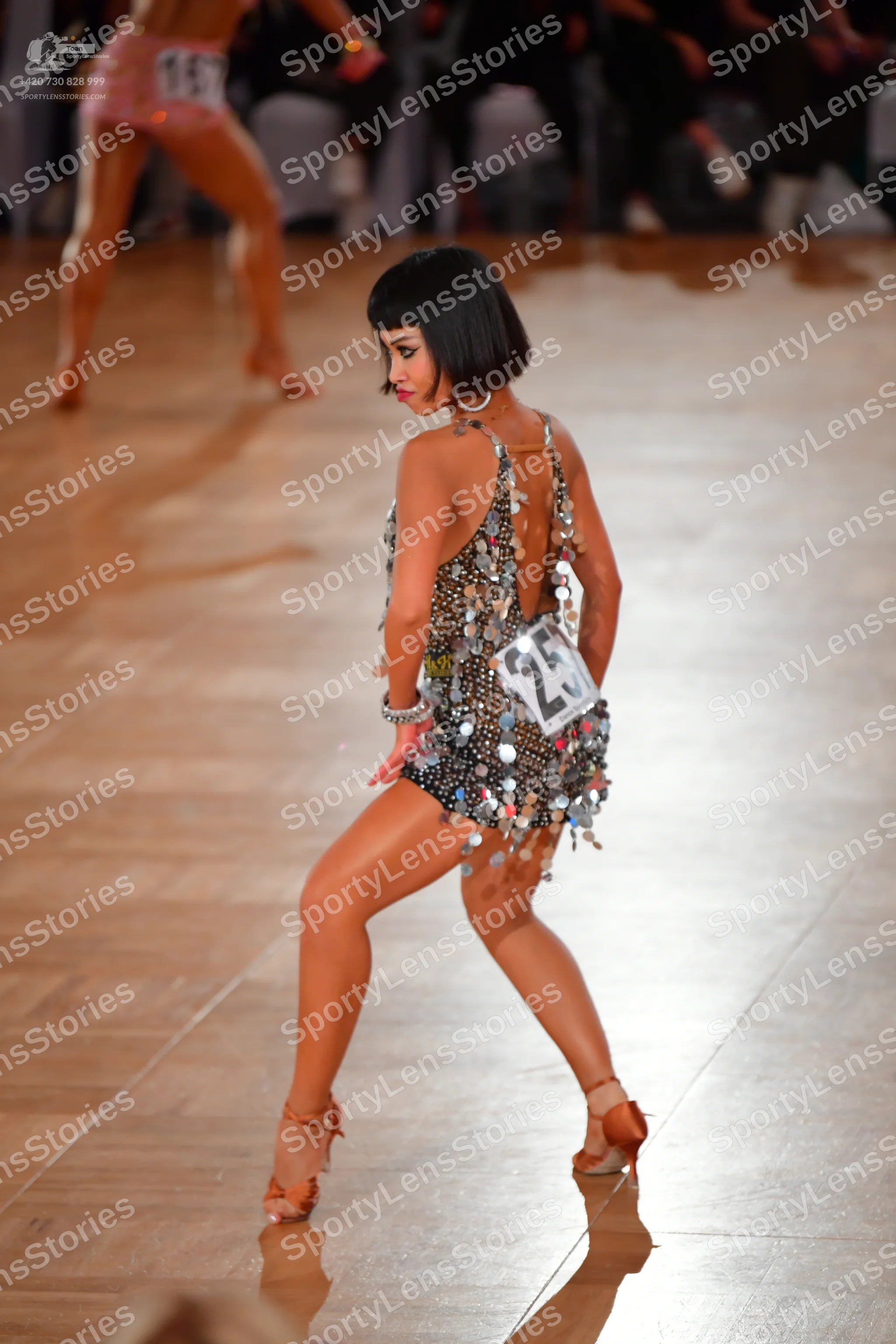 Dancesport competitor #28, #167: Female dancer in foreground: black latin dress with silver sequins and metallic