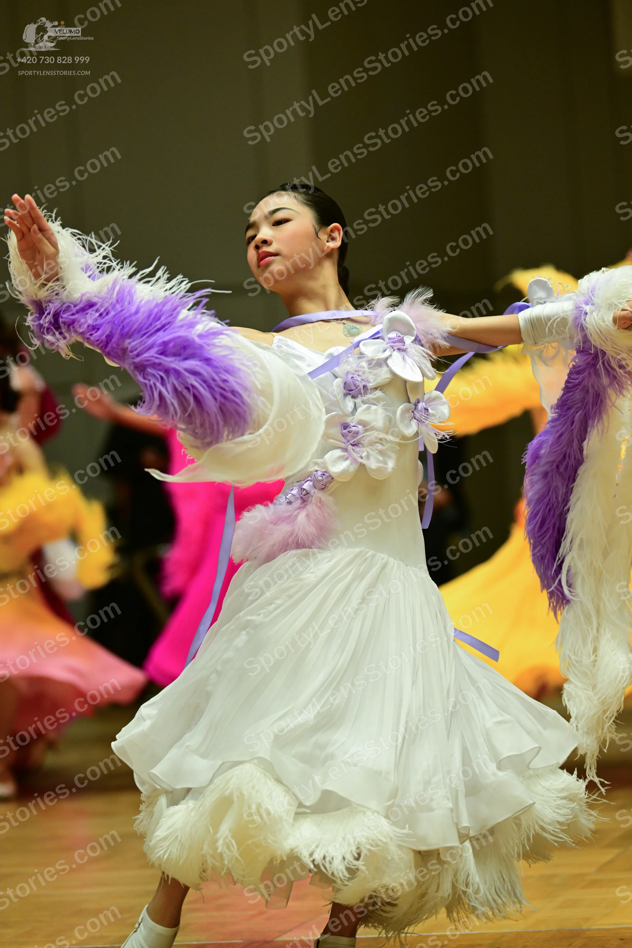 Dancesport competitor: Here’s a breakdown of the dancers' costumes in the photo, formatted as requested
