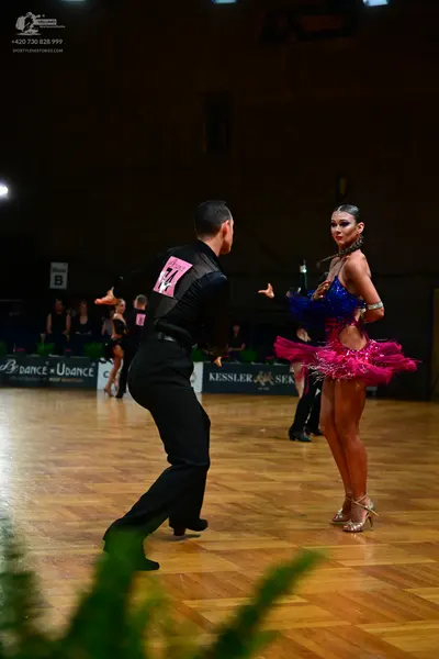 Dancesport competitor #16: Male dancer: black long-sleeved dance shirt and black trousers