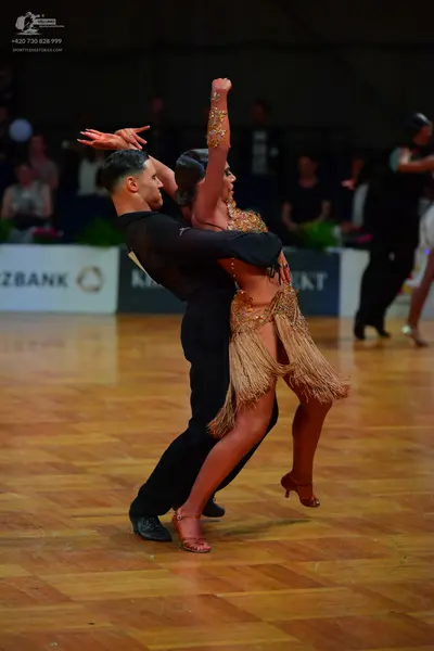 Dancesport competitor: Male dancer: black long-sleeved shirt and trousers