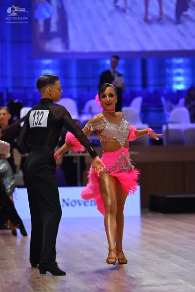 Dancesport competitor: Male dancer: black long-sleeved top and black trousers
