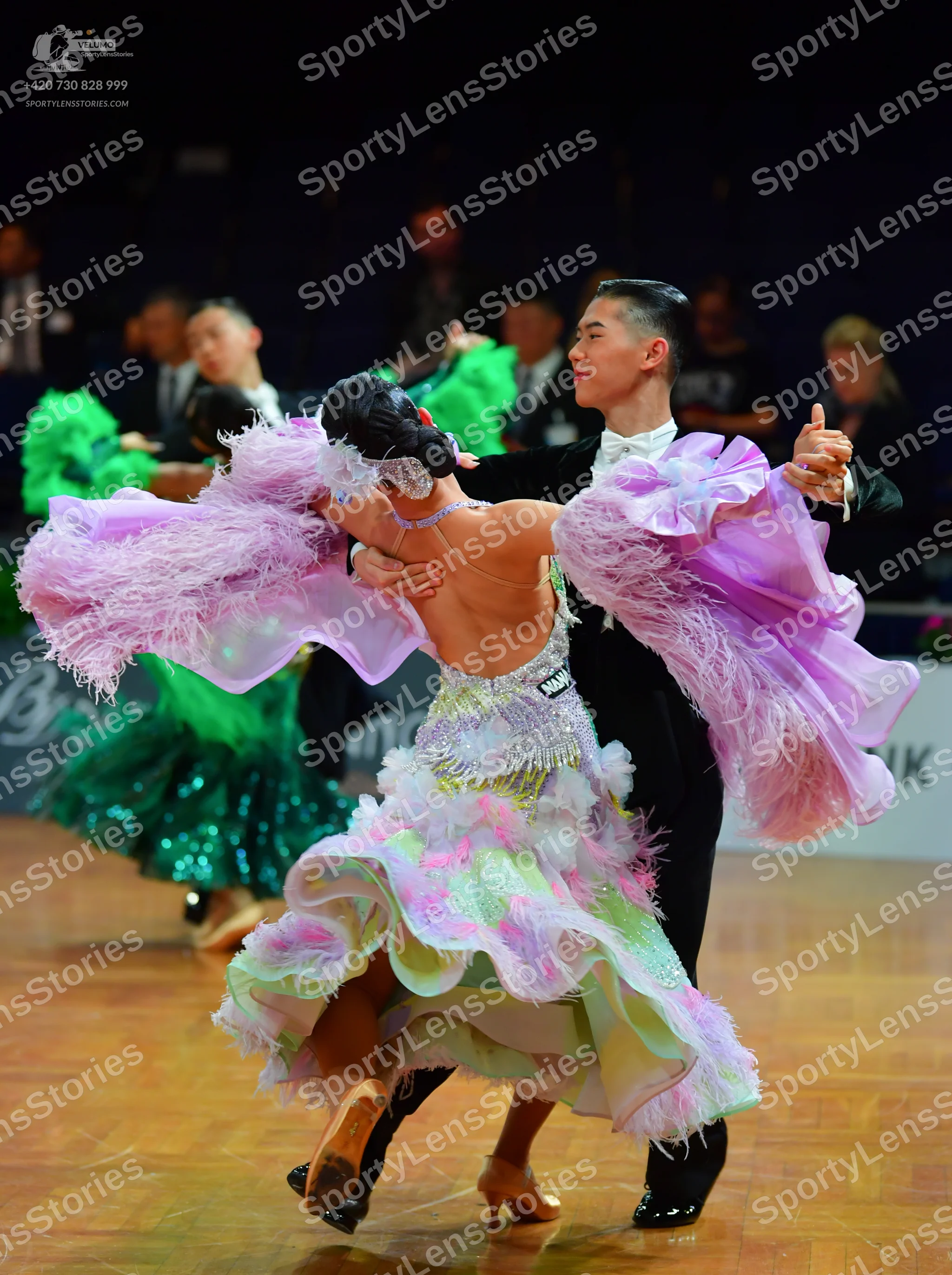 Dancesport competitor: Female dancer: lavender, white, and mint green Latin dress with a heavily ruffle