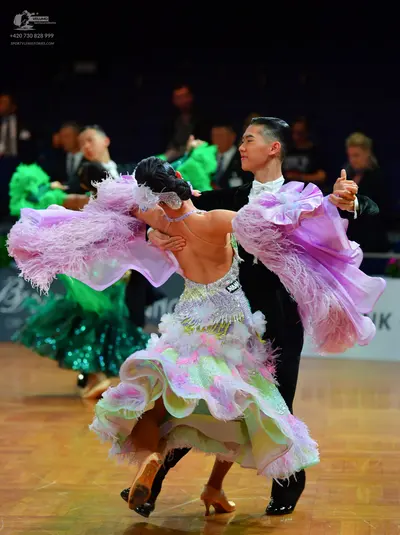 Dancesport competitor: Female dancer: lavender, white, and mint green Latin dress with a heavily ruffle