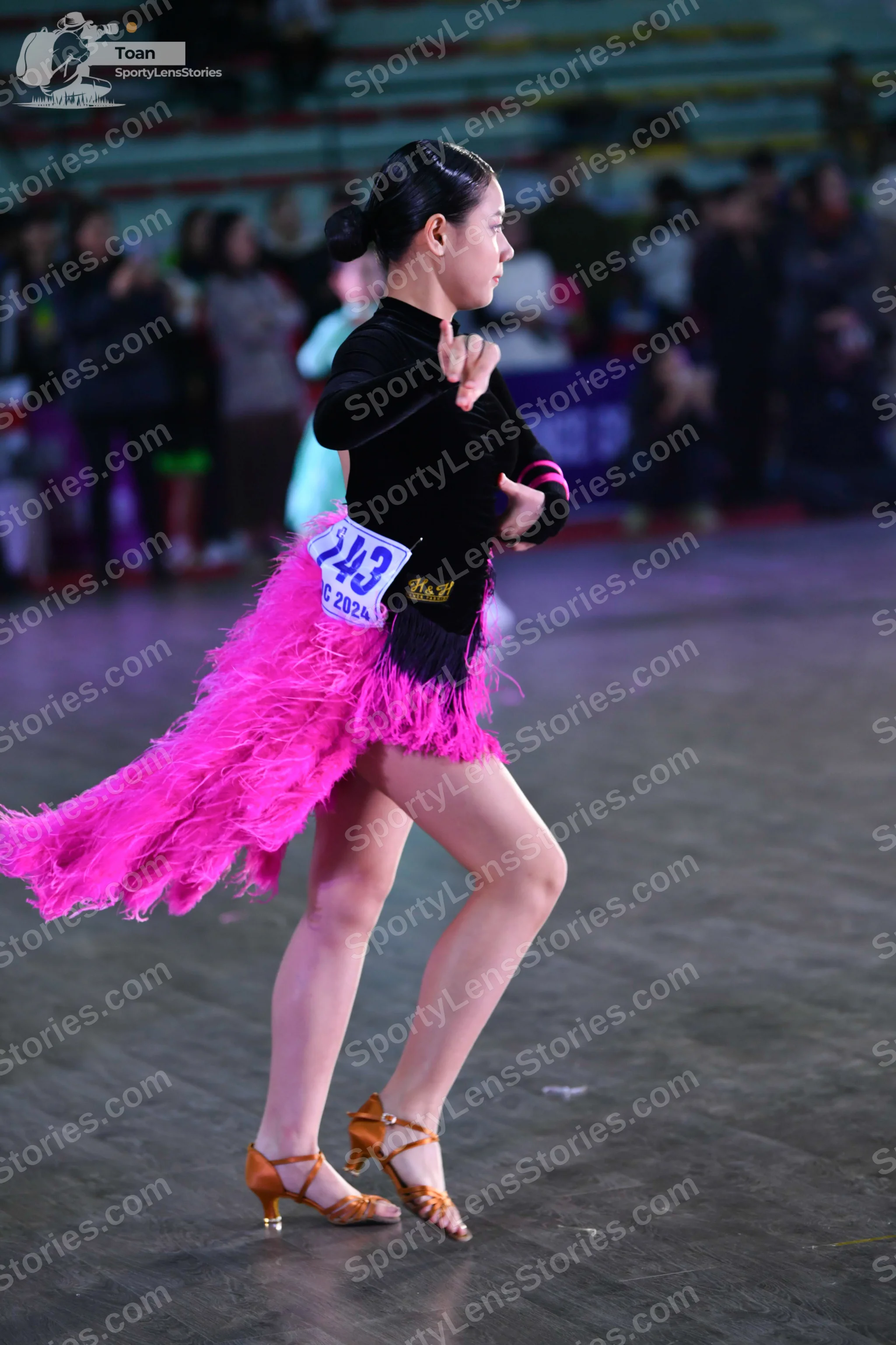 Dancesport competitor: ** Female: Pink Latin Dress - The dancer is wearing a vibrant pink Latin dress