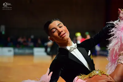 Dancesport competitor: Male dancer: black suit with a white shirt and white bow tie
