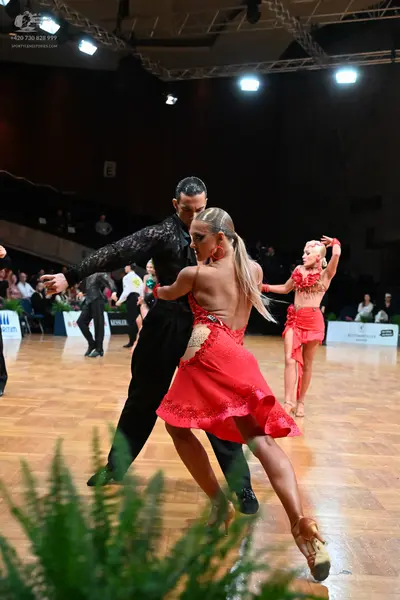 Dancesport competitor: Male dancer: black long-sleeved sequined shirt and black trousers
