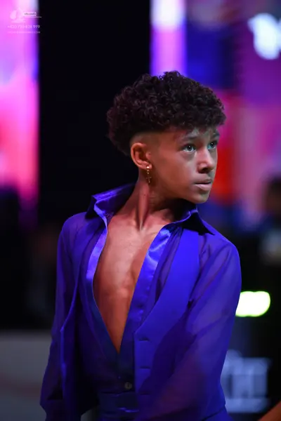 Dancesport competitor: Male dancer: blue satin-like shirt with a deep V-neck