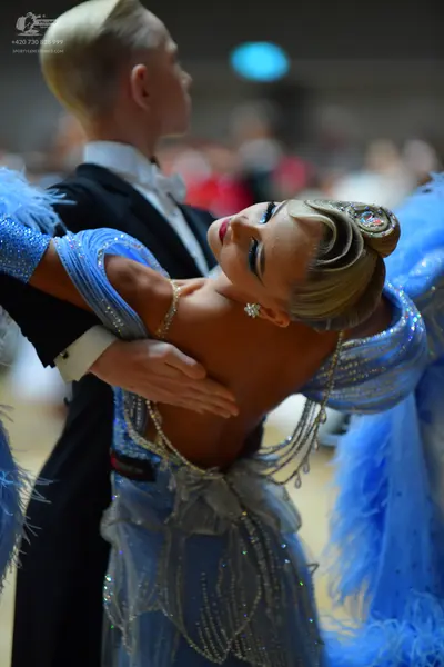 Dancesport competitor: Male dancer: black suit with a white shirt and white bow tie