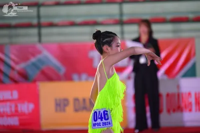 Dancesport competitor: ** Female
*   **Color:** Bright Yellow 
*   **Fabric:** Fringe (likely silk or a